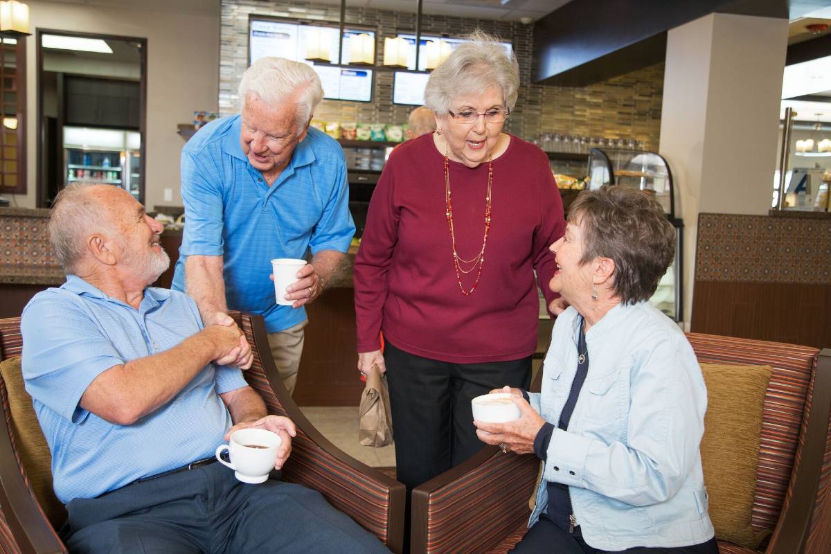 a group of senior friends enjoy coffee together