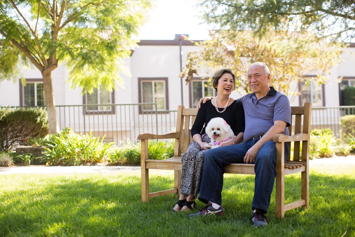 senior couple sitting outside retirement community San Diego