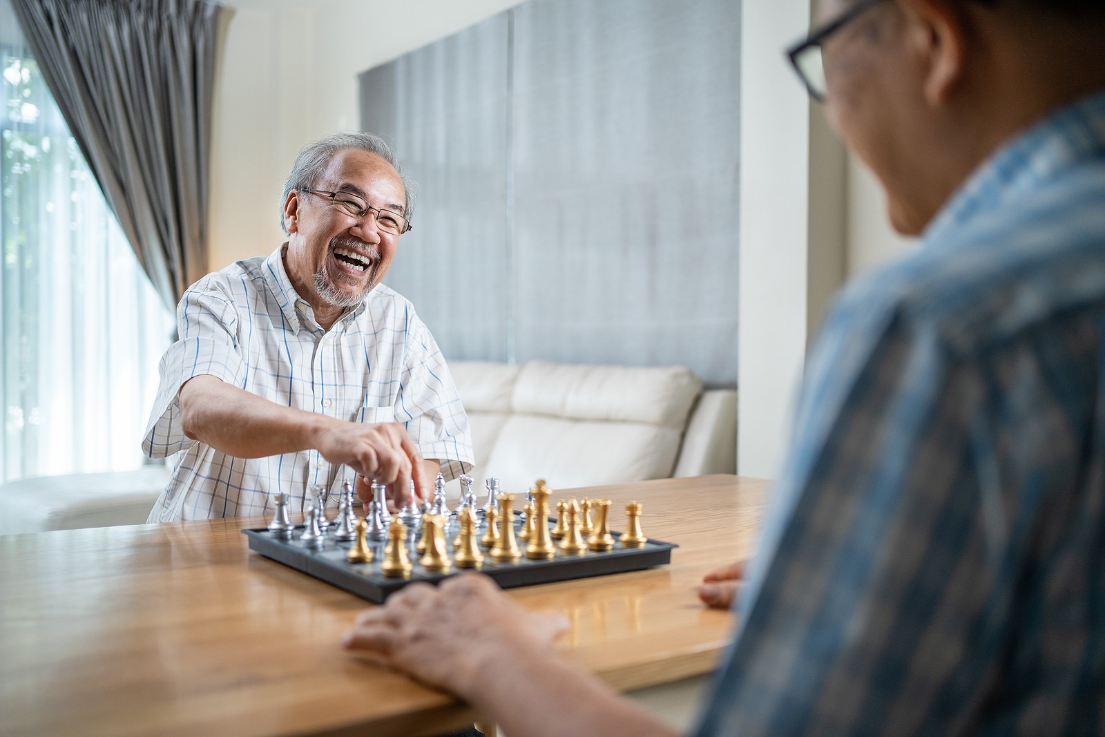Senior men playing chess in retirement community San diego.