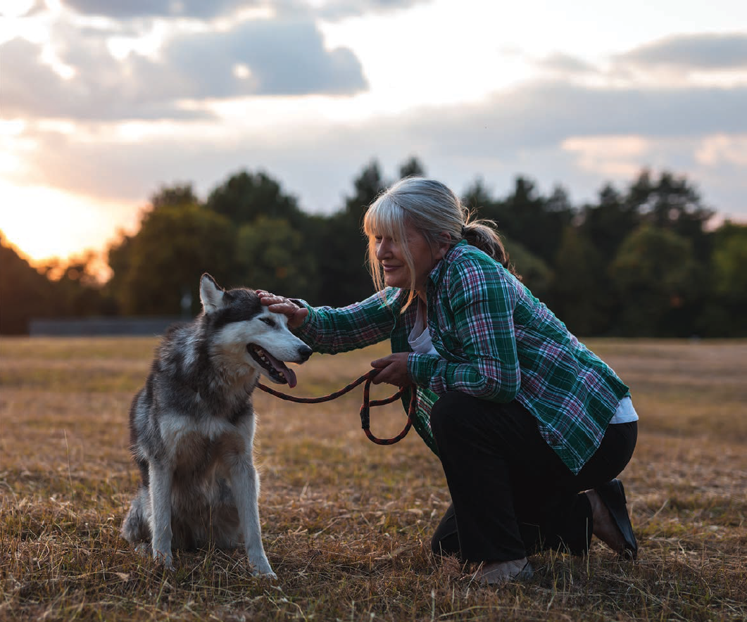 senior woman petting her dog