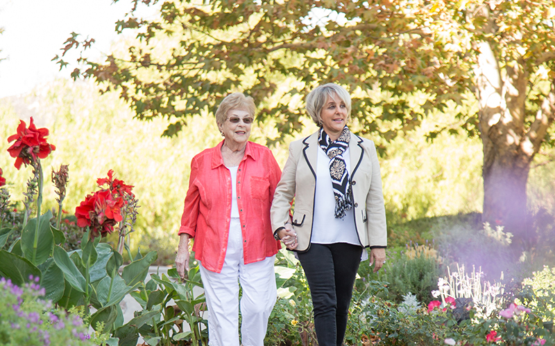 Senior women walking through the garden